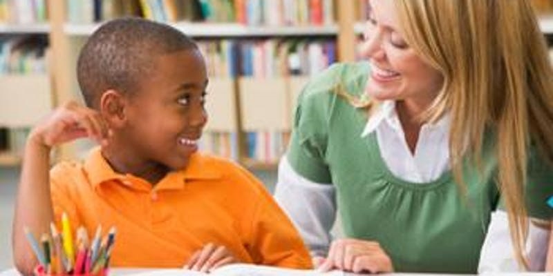 male child smiling at teacher