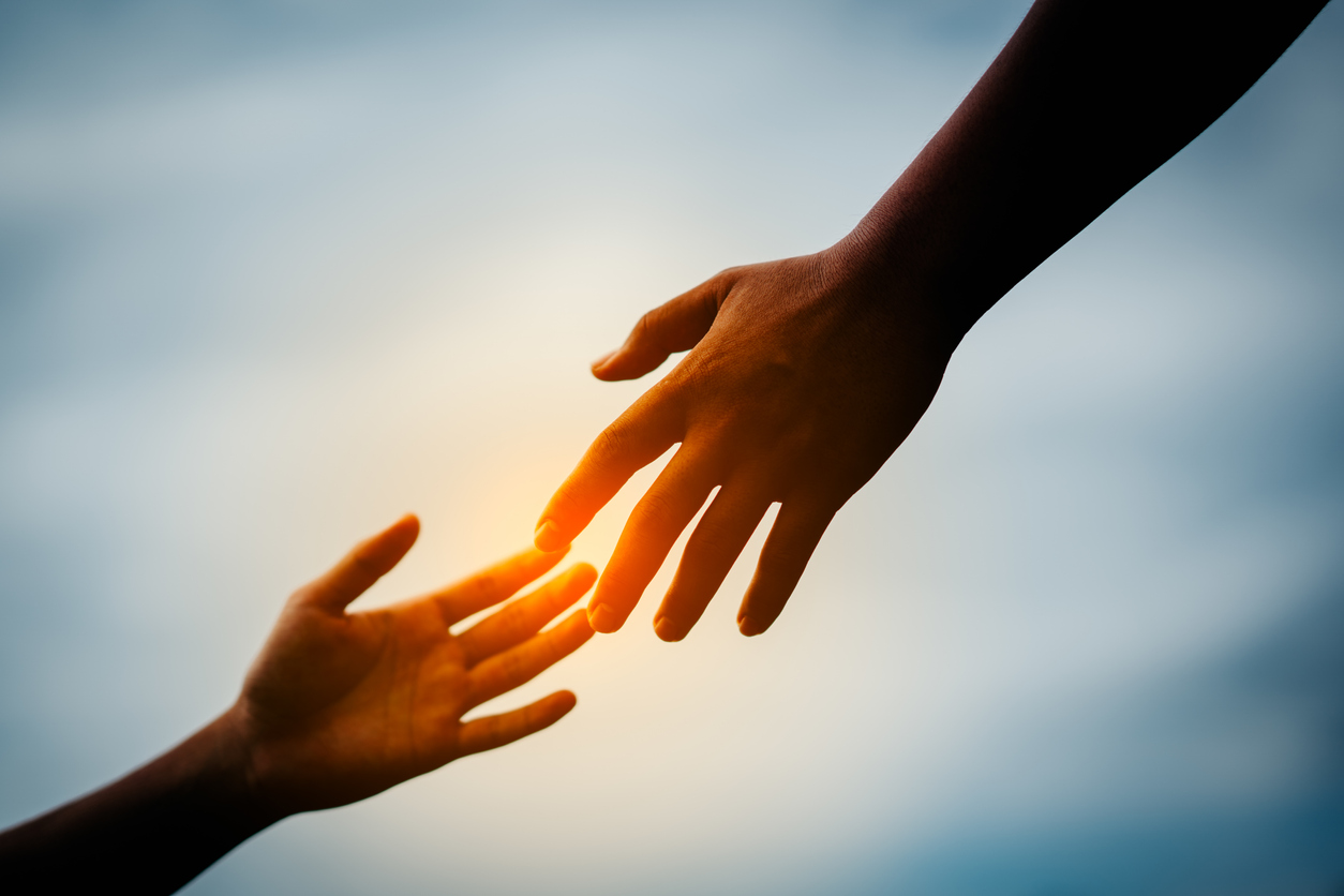 Two hands outstretched indicating help and support for one another