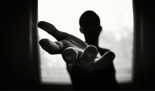 image of a person reaching out their hand