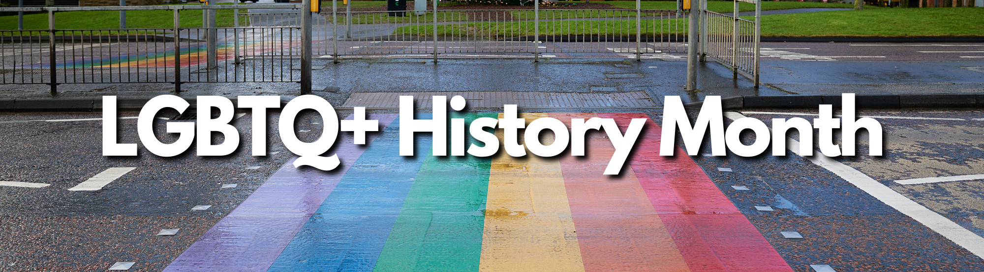 Image of a crosswalk painted in rainbow colors with the text LGBTW+ History Month