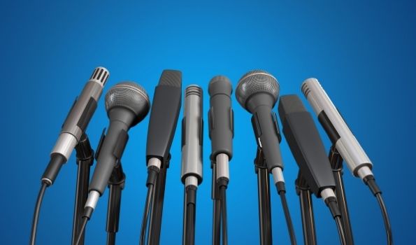 A collection of microphones in front of a plain background