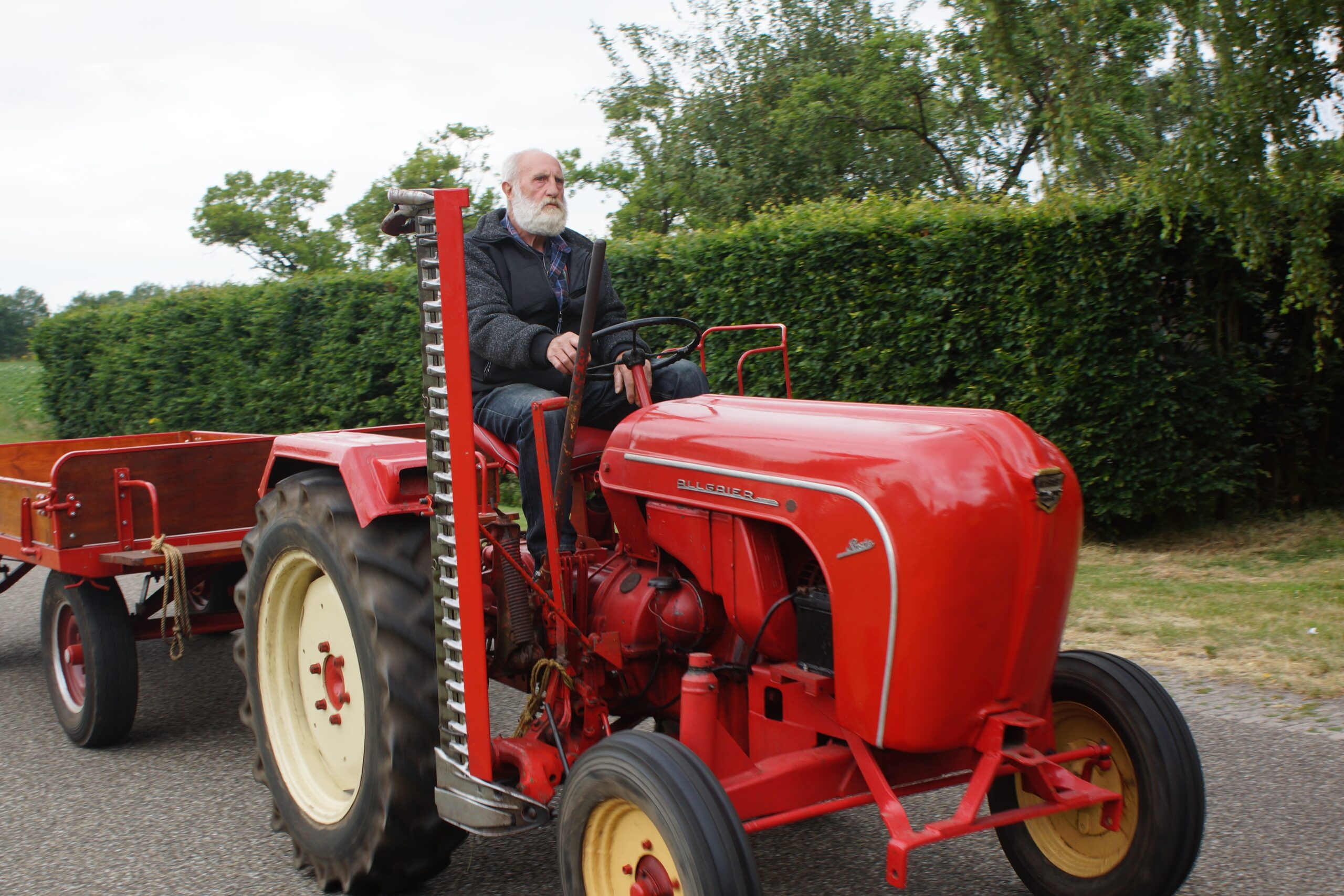Man riding red tractor