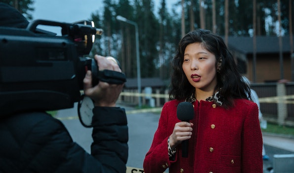 woman in red and black sweater talking to camera
