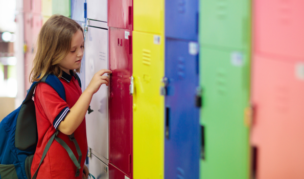 A child looks at a locker. 