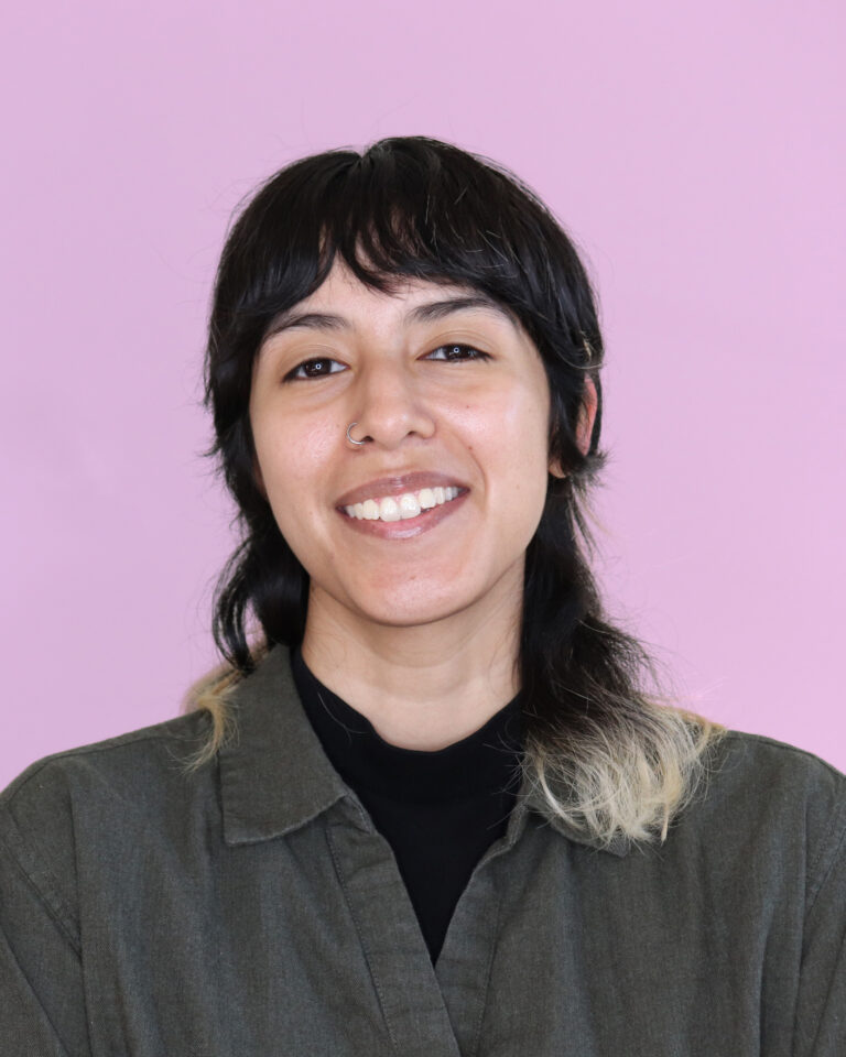 Headshot image of Hispanic person in their late 20's with a purple background.