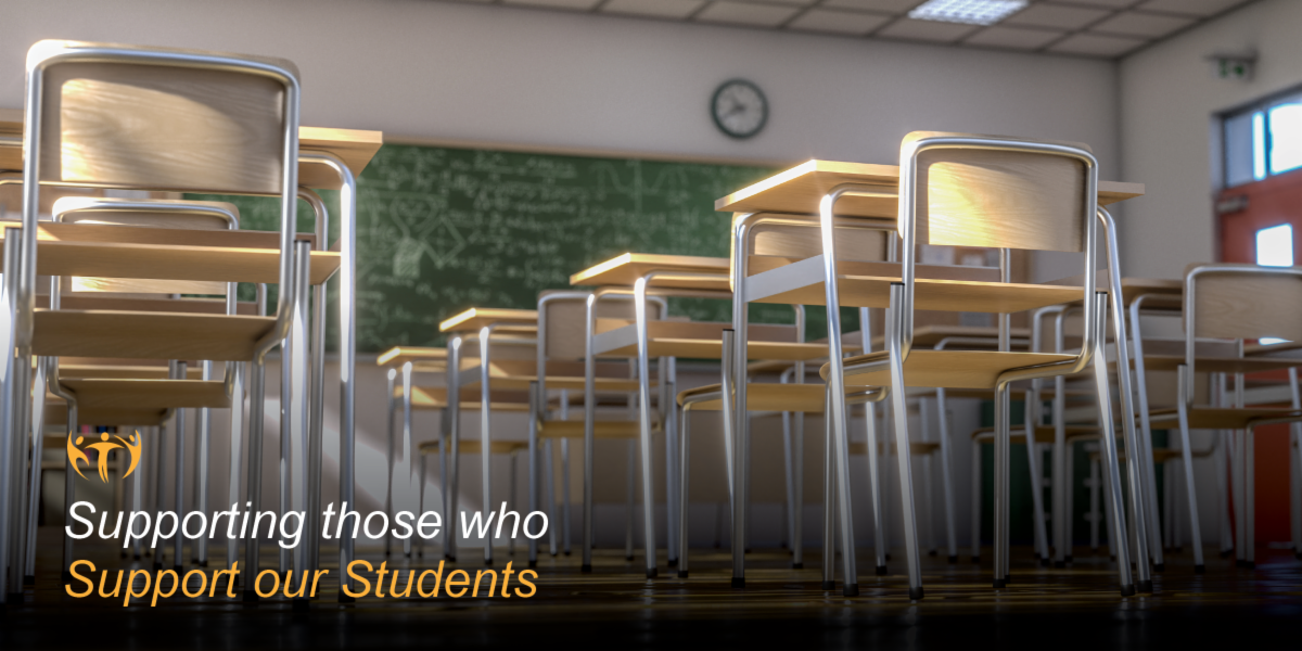 Supporting those who support of students: Classroom of student desks appear against a chalkboard full of lessons