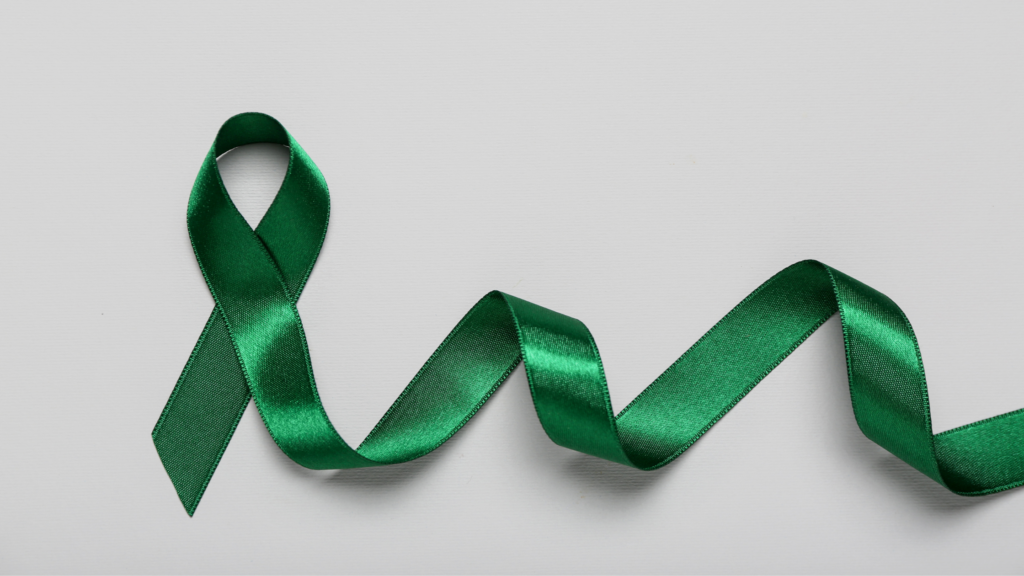 A green ribbon against a solid off white background